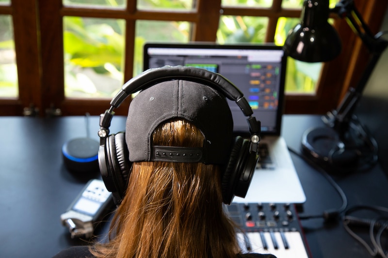 Image of woman using her computer and home studio.