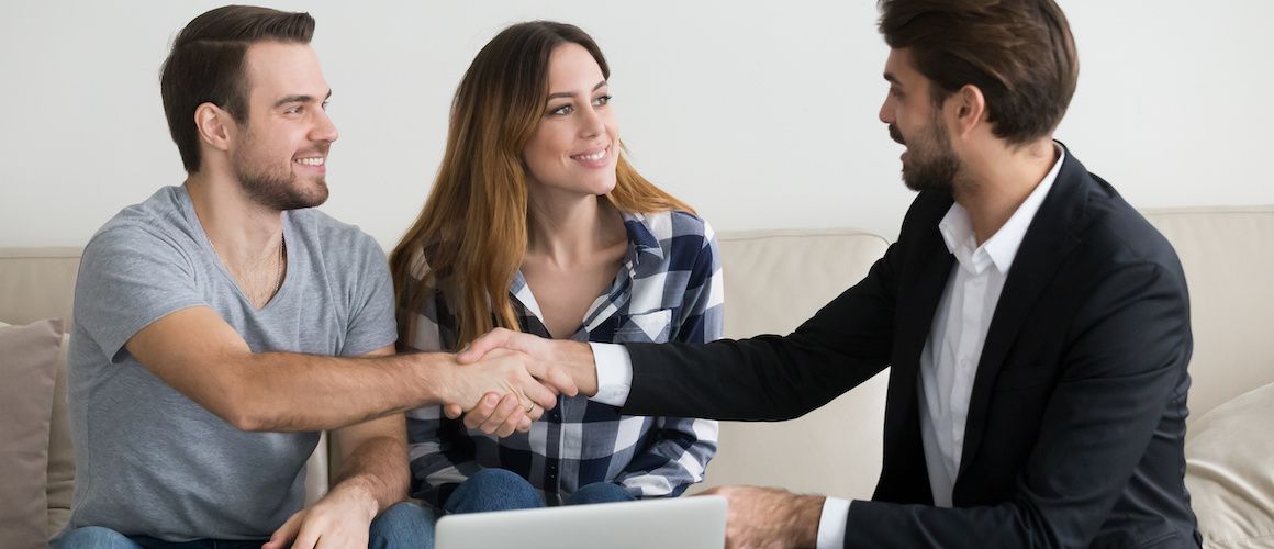 RHB Assets From IGX: Young couple shaking hands over a deal