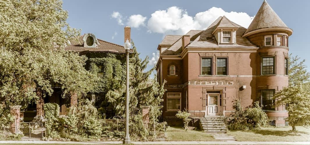 A majestic brick house with a towering turret, showcasing timeless architecture and grandeur.