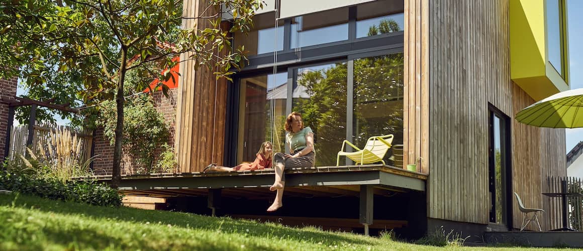 Mother and daughter on back deck of new home.