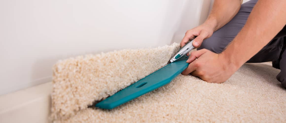 RHB Assets From IGX: Man installing carpet in a home renovation project.