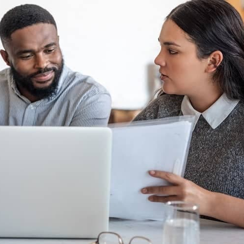 A couple discussing underwriting with a lawyer, possibly related to a mortgage process.