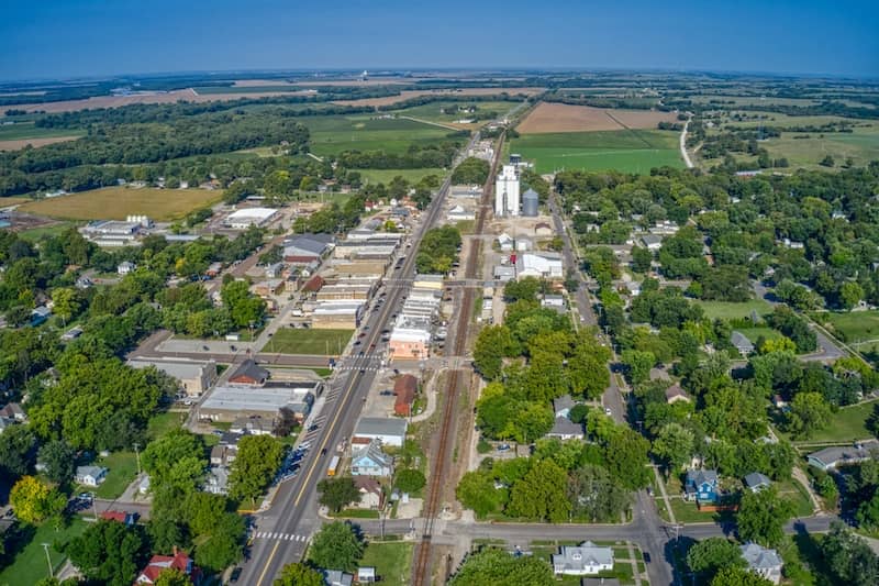 Aerial view of small town St. Mary's surrounded by forest and farms in Kansas.