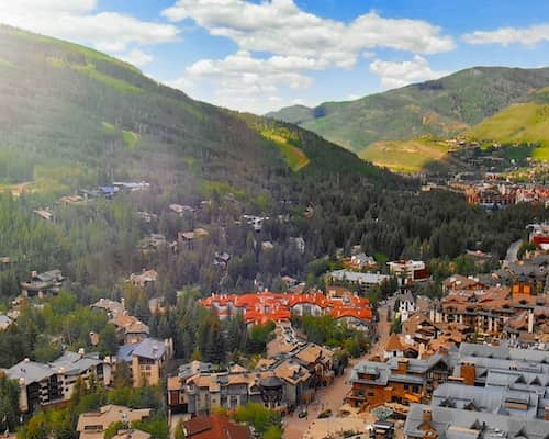 Aerial view of Vail Colorado with mountains in background.
