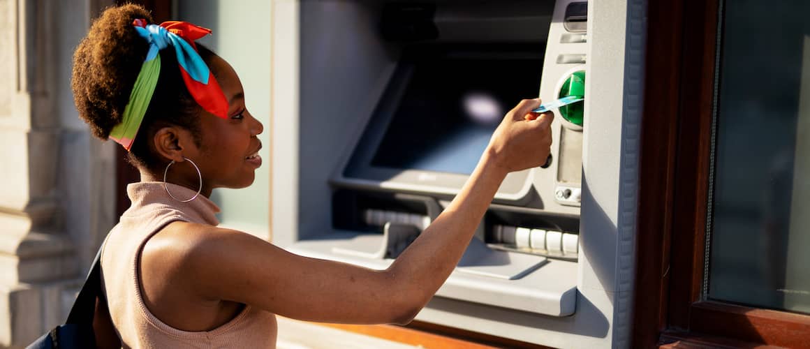 Woman withdrawing money from ATM.