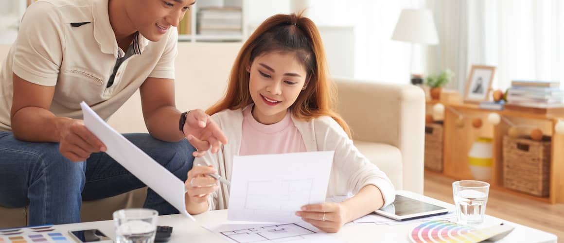 Young couple going over home improvement plans.