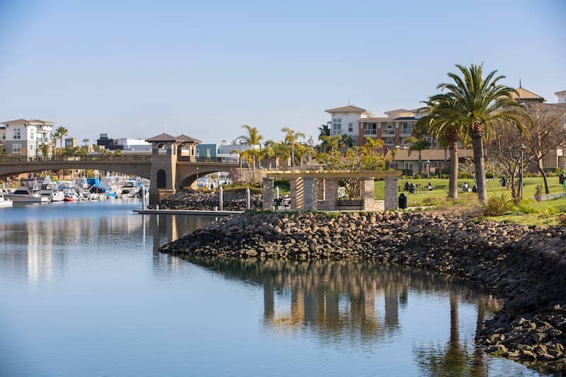 RHB Assets From IGX: Aerial view of Oxnard, California's sunny coastline and palm tree-lined streets.