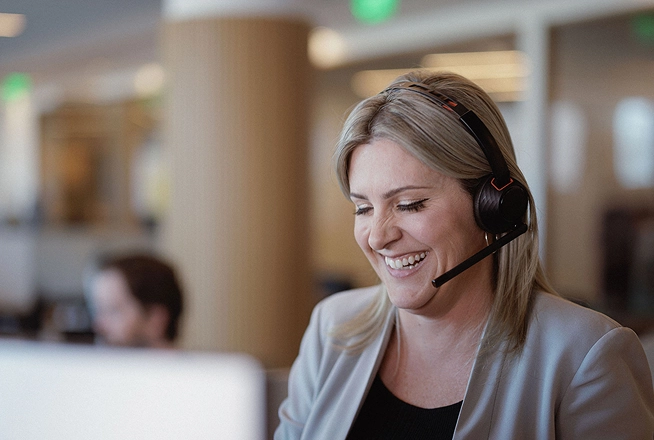 A Rocket Mortgage home loan expert wearing a headset helps a client review their mortgage.