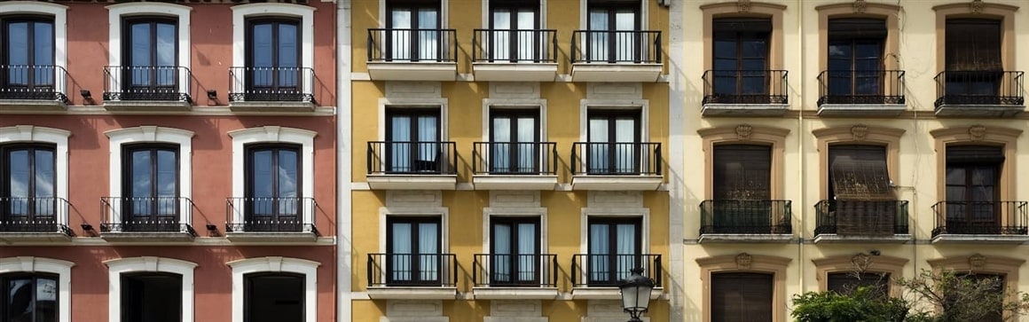 Image showing vibrant buildings with balconies in a row possibly indicating good investment opportunities.