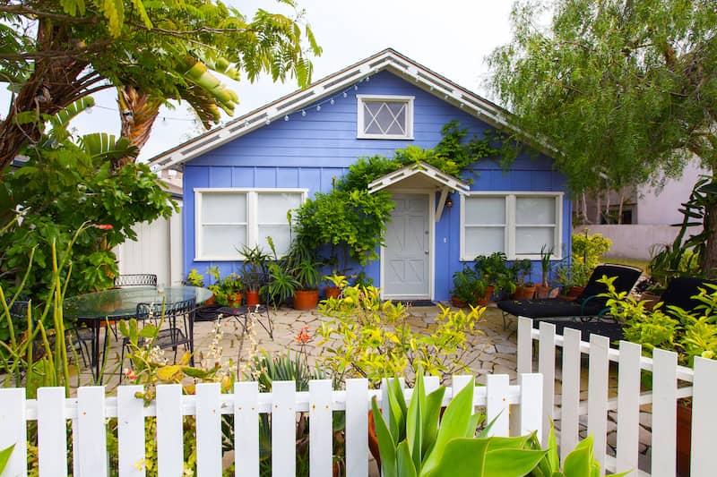 Blue cottage with white picket fence.