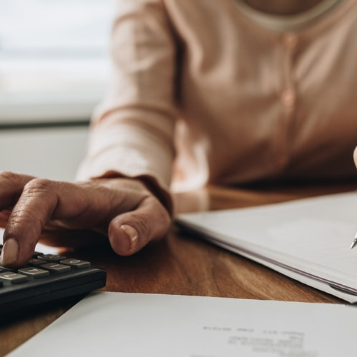 Probably a women calculating her taxes or finances.