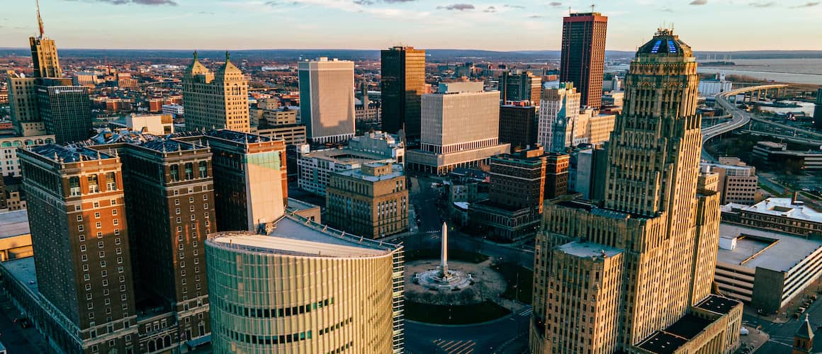 RHB Assets From IGX: Stunning panoramic view of Buffalo cityscape with modern and historic buildings under a blue sky.