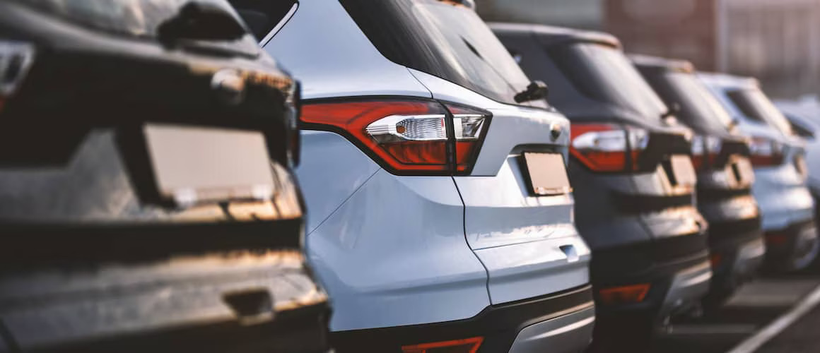 Row of used cars at dealership.