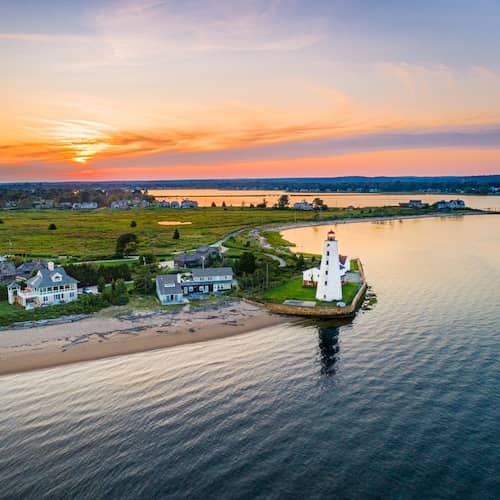 View of homes and the Lynde Lighthouse along the shoreline of the Connecticut River in Old Saybrook, Connecticut.