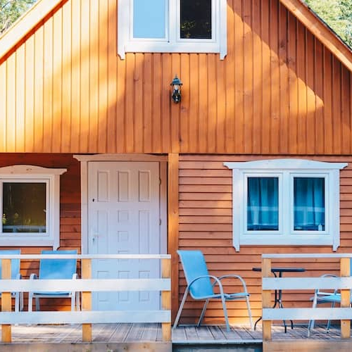 Small Norwegian-style cabin with front porch.
