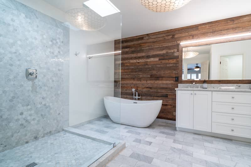 RHB Assets From IGX: Bathroom with freestanding tub and wood accent wall