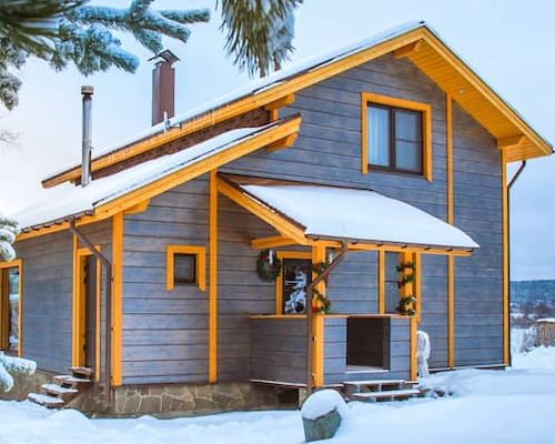 Country cottage, showcasing a cozy rural dwelling with natural surroundings in snowy weather.