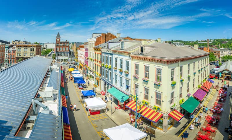 RHB Assets From IGX: Aerial view of colorful houses and street vendors in a lively neighborhood