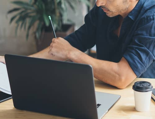 A man calculating his taxes or finances.