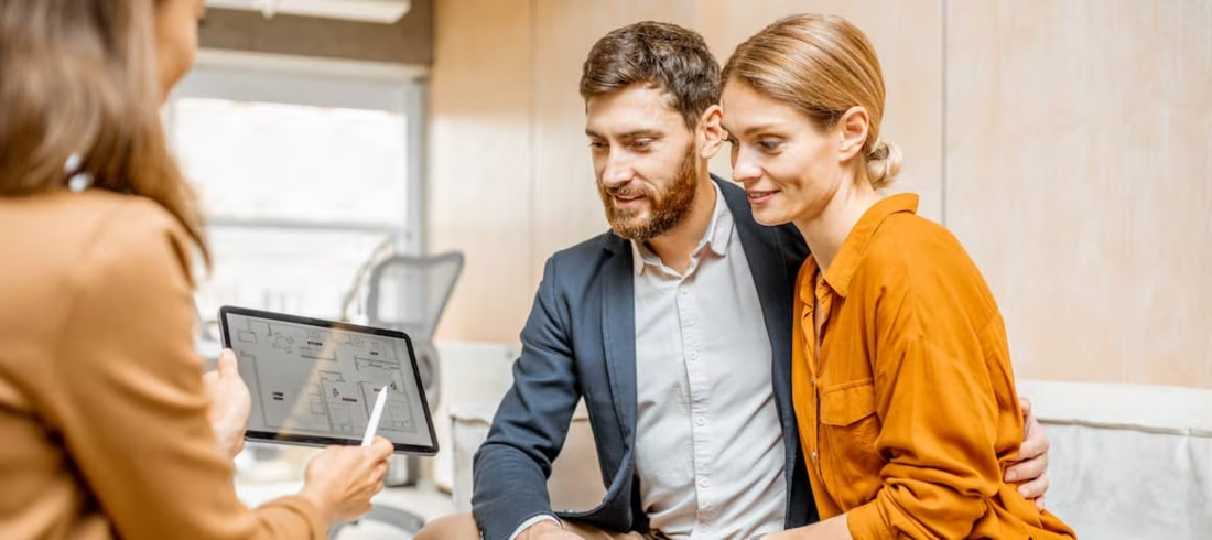 Couple speaking to a financial advisor.