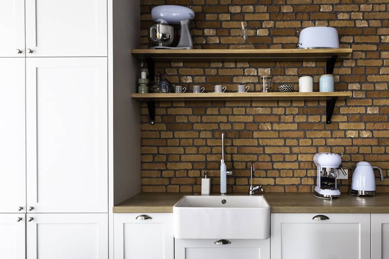 RHB Assets From IGX: Exposed brick backsplash in a rustic, contemporary kitchen.