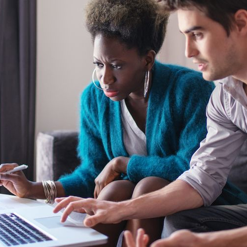 A young couple looking for a house, symbolizing the process of home search or property hunting.