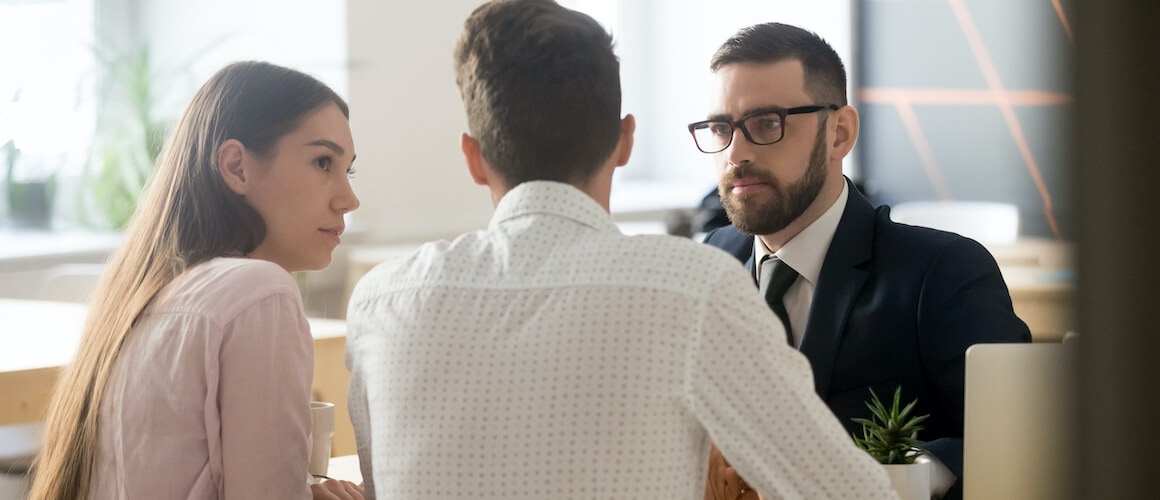 A young couple breaking up with a realtor, possibly indicating a change in their home search or real estate plans.