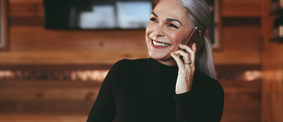 A woman on phone possibly talking about a good moment with some family member or friend.