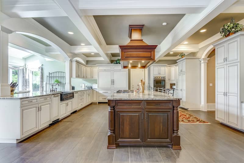 RHB Assets From IGX: Sophisticated living room with coffered ceiling and cozy seating arrangement.