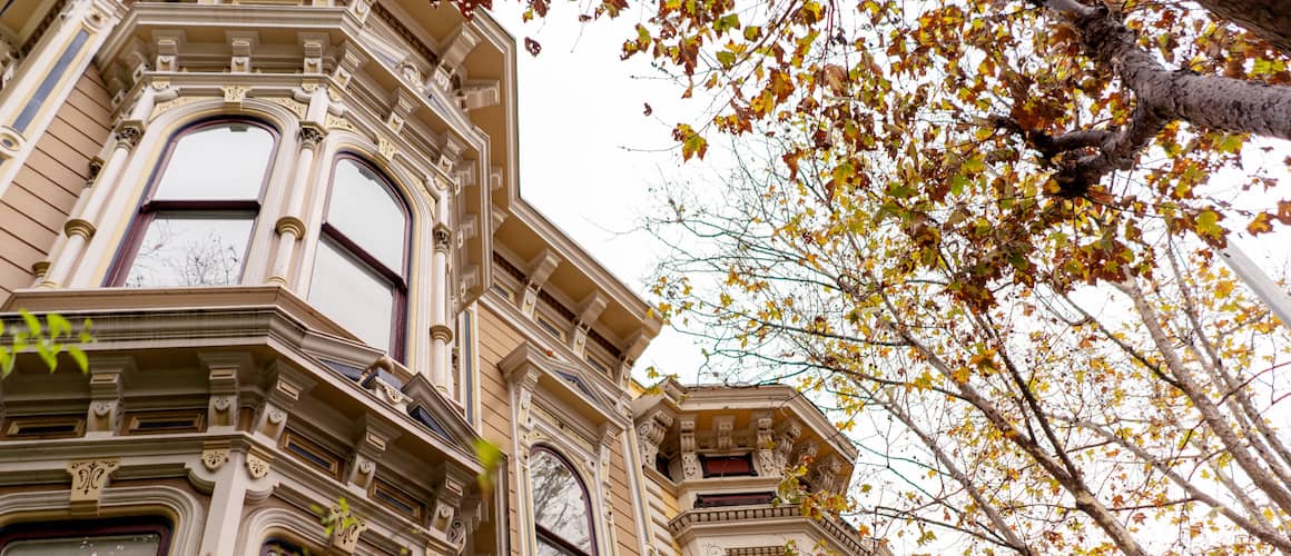 A Victorian-style home with bay windows, showcasing architectural features of a specific residential style.