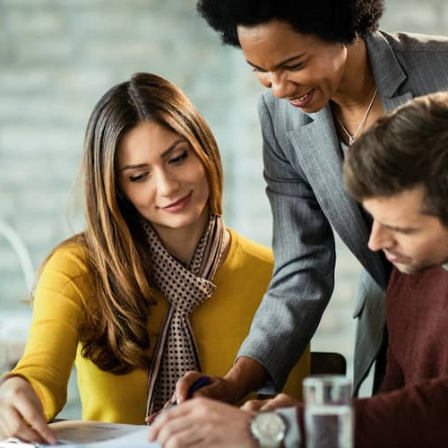A couple reviewing closing documents, potentially associated with a property closing or finalization process.