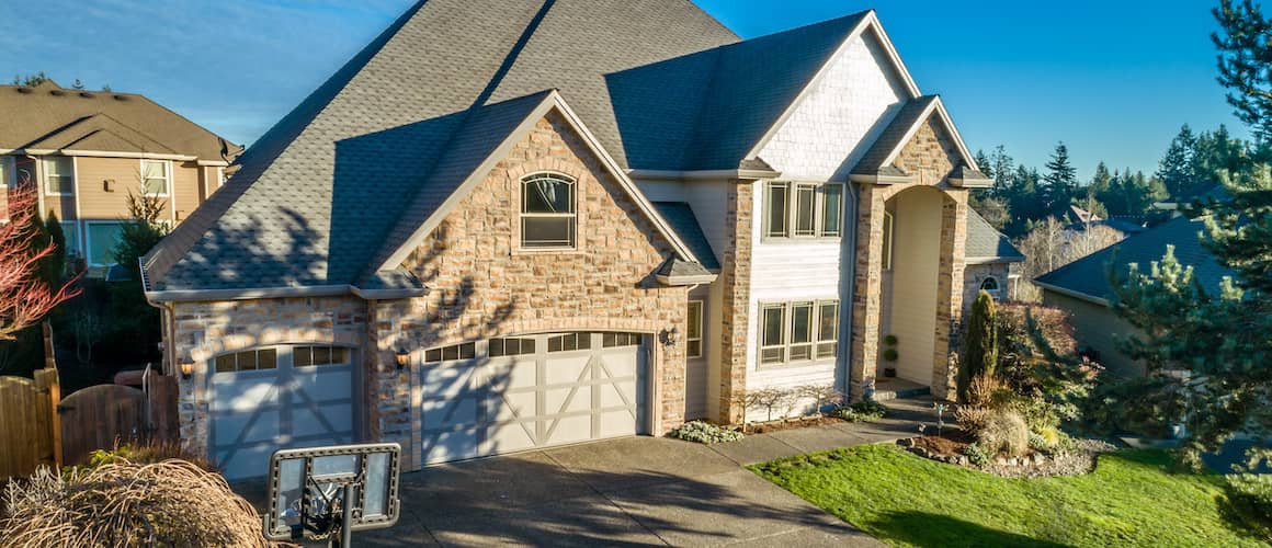 Large, multi-story home with natural looking brick exterior