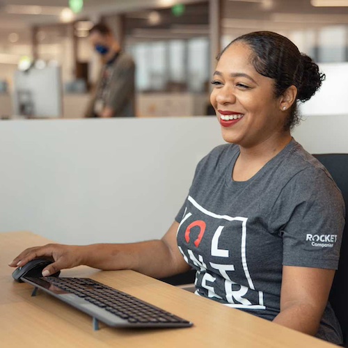 Woman smiling while working at her desk.