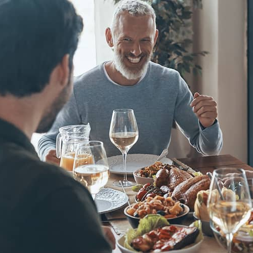 A family enjoying dinner on dining table.