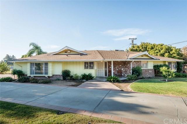 RHB Assets From IGX: Charming Fresno house with a well-manicured lawn and red front door.