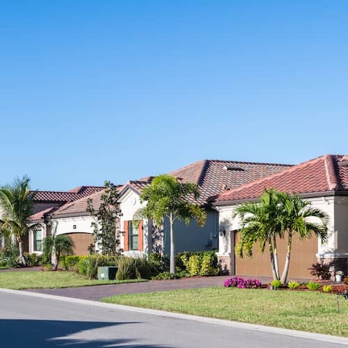New single family home development with recently planted Palm trees in Bonita Springs Florida.
