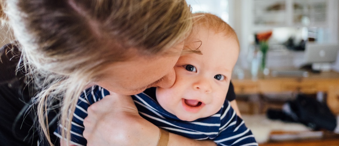 Image of mom holding her child after finalizing adoption papers.