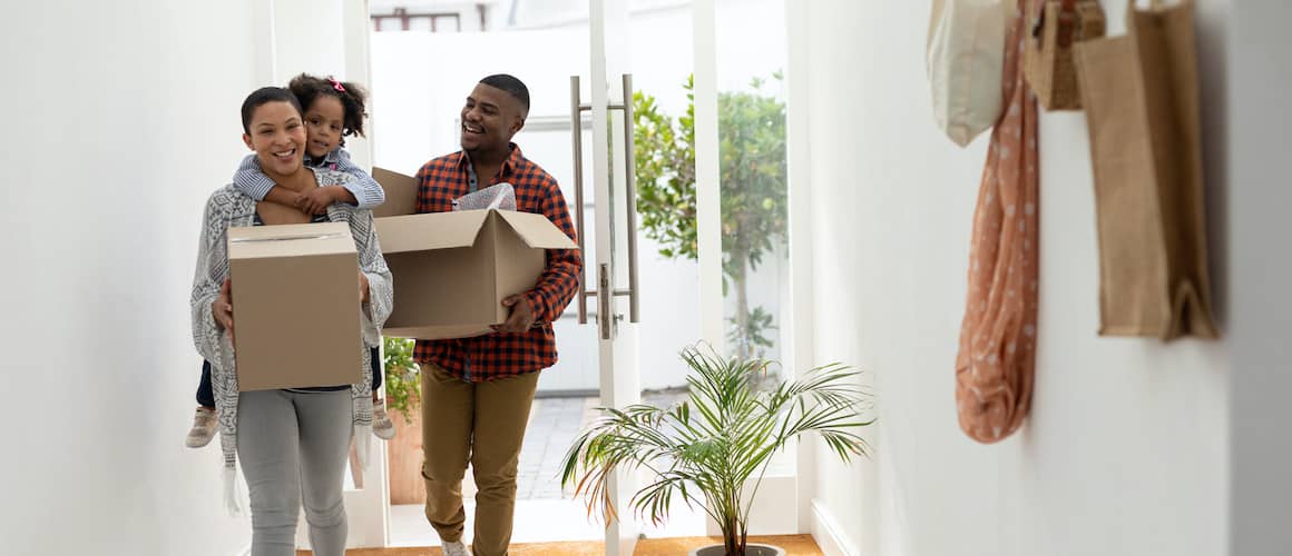 A young family moving in, indicating a new chapter in home ownership or relocation.