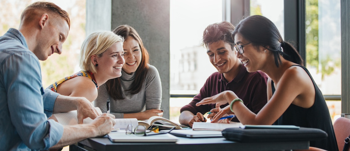 Group of college students sitting at a table.