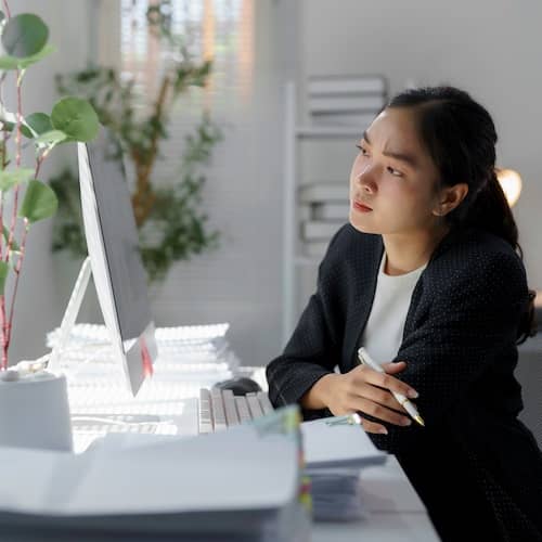 Young woman making an important decision in front of her computer.