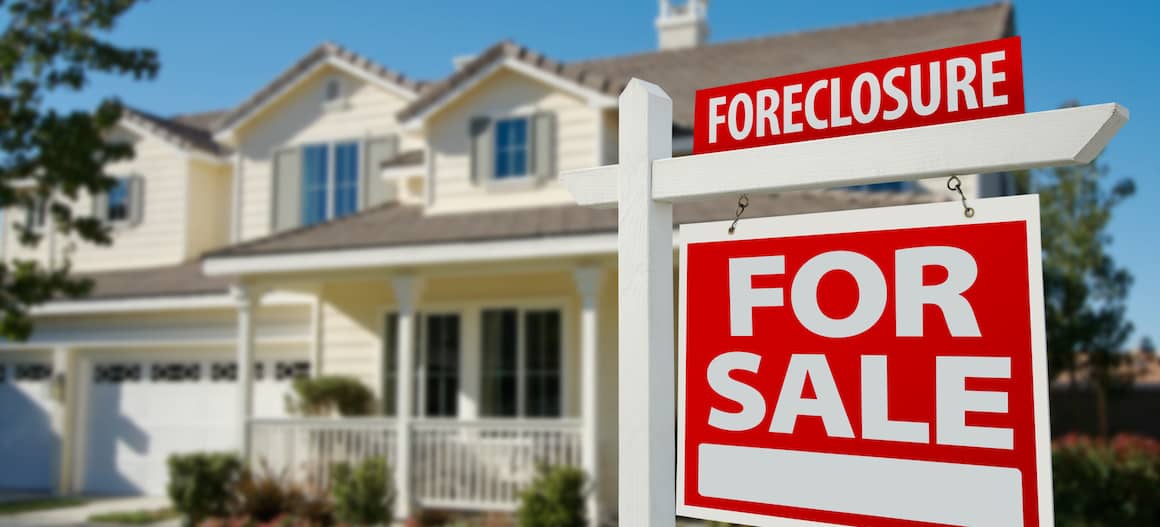 A foreclosed house for sale, depicting a distressed property.