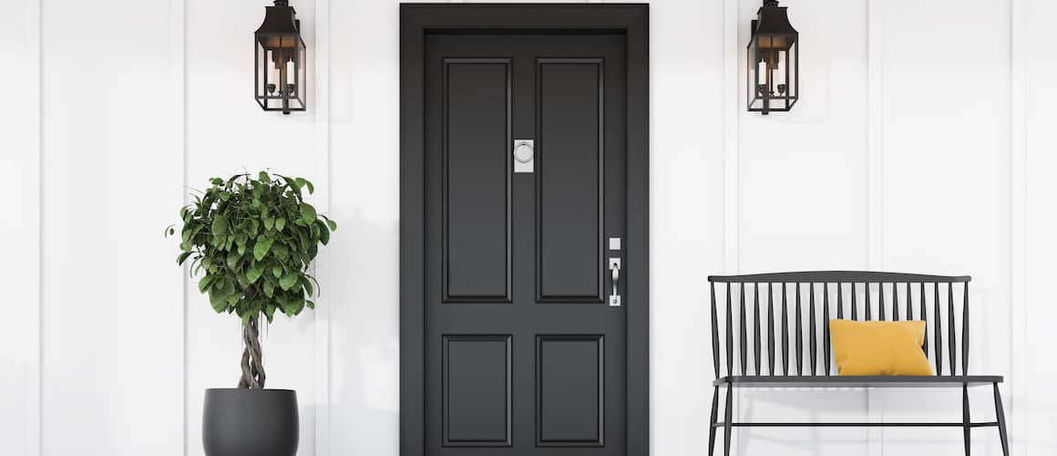  Black front door with bench on porch and potted plant.