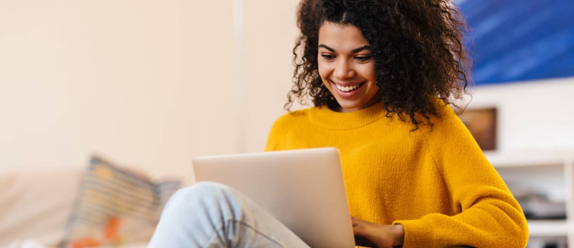 Woman in chair with laptop.