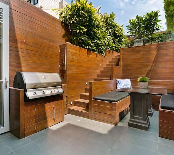 RHB Assets From IGX: A stylish outdoor kitchen with built-in cabinets and a grilling station.