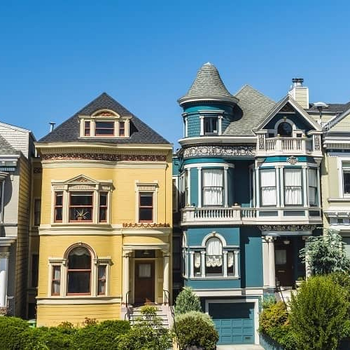 Multiple houses in a row, representing a residential area or neighborhood.