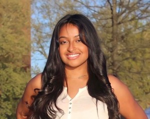 Headshot of Angelica Victor standing in front of background of trees.