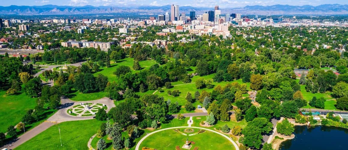 Aerial view of a lush green park near a city.