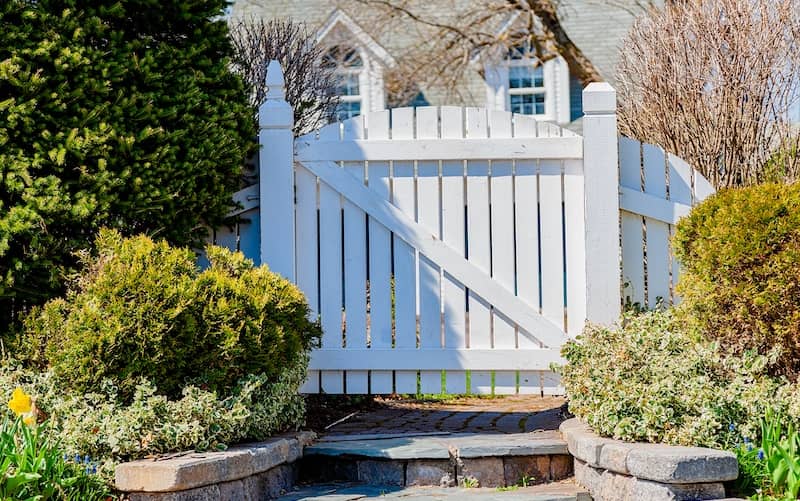 Stately wooden fence entrance to front yard.