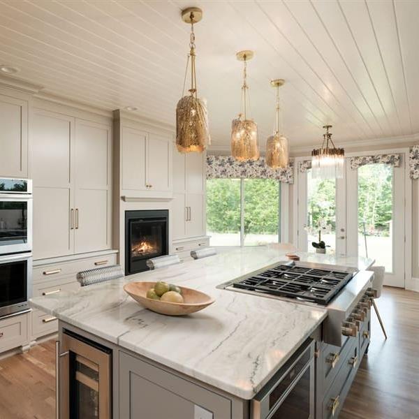 A clean transitional decor style kitchen on a sunny day.