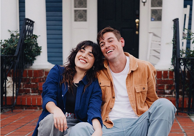 Couple sitting together on front steps.